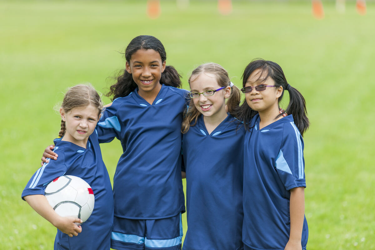 A youth sports team huddled together